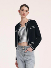 a lady in a black pure wool knit crop cardigan with jeans